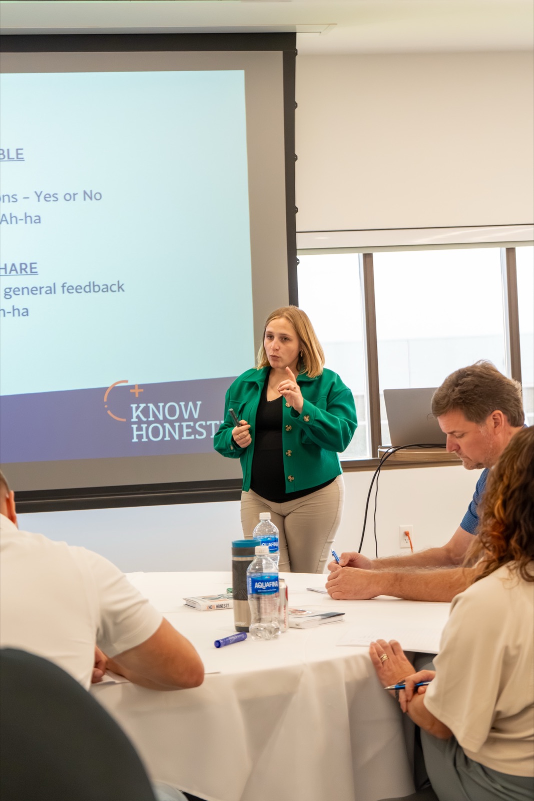 Attendees writing at their tables during a Know Honesty&trade; workshop